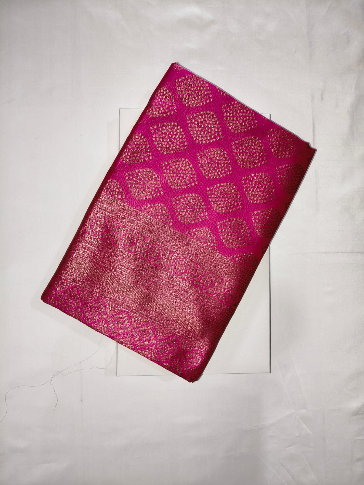 Bold Rani Pink Silk featuring All-Over Gold Zari Check Patterns and a Broad, Intricately Woven Border