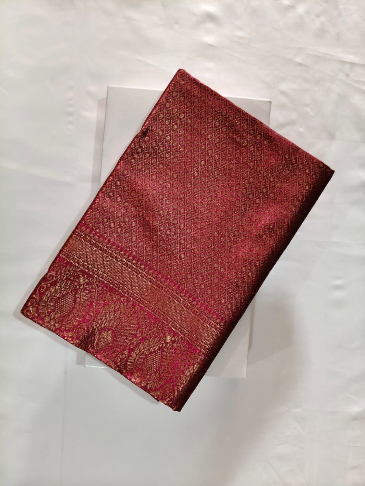 Luxurious Maroon Silk featuring All-Over Geometric Zari Weaving and a Wide Border with Traditional Bird Motifs.