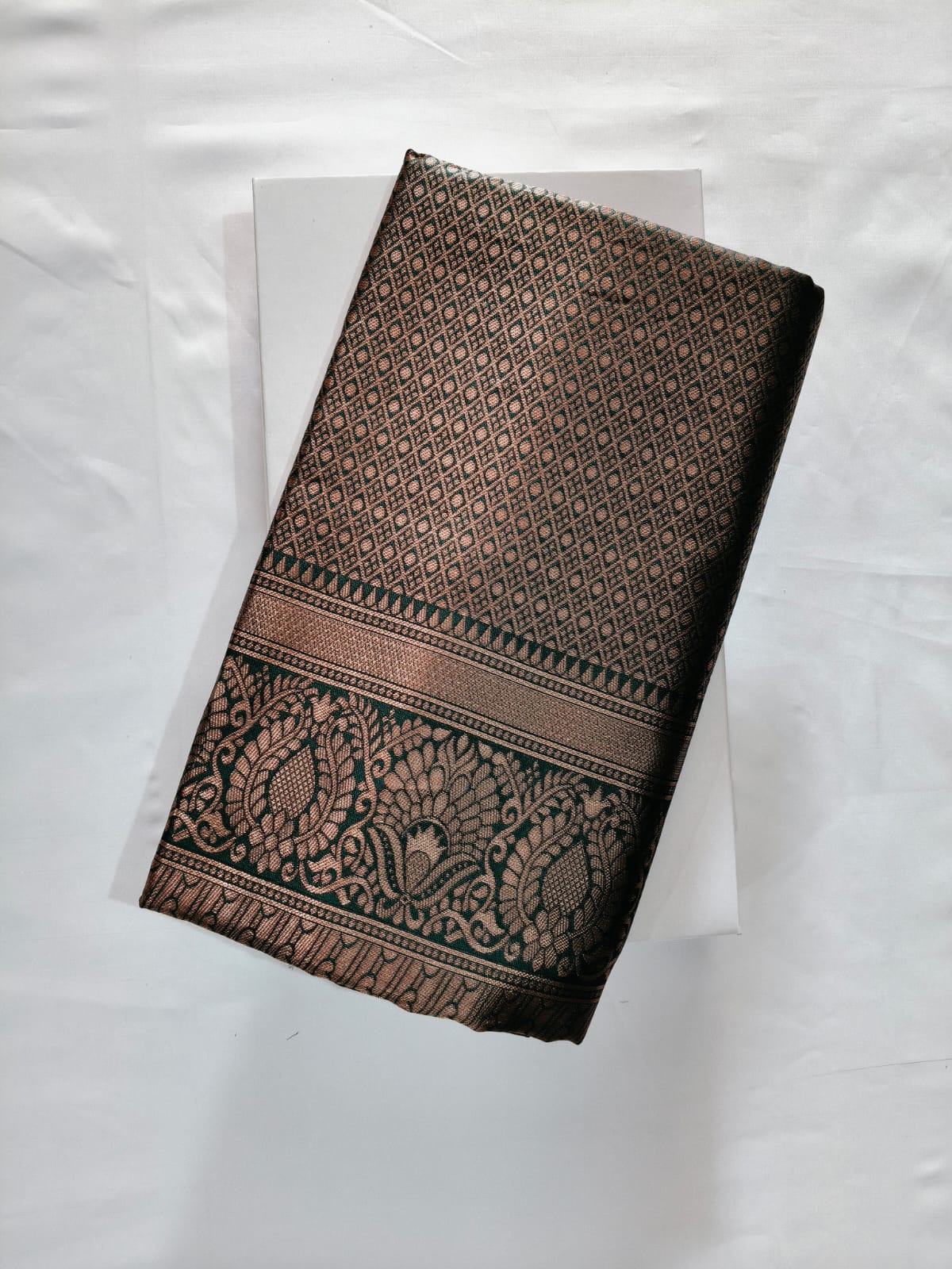 Deep Dual-Tone Green Silk with Geometric Zari Weave and a Grand Border featuring Detailed Floral Motifs