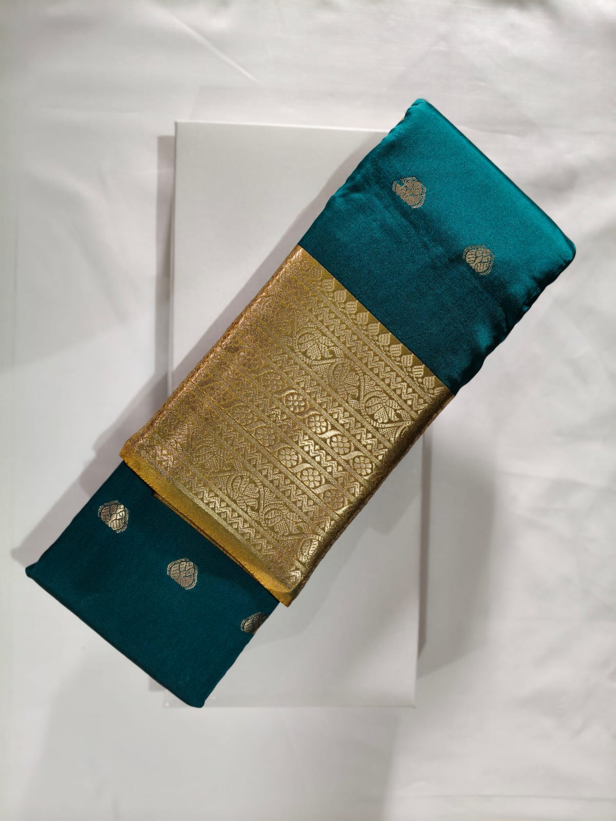 Deep Peacock Blue Silk adorned with an Opulent Gold Zari Border