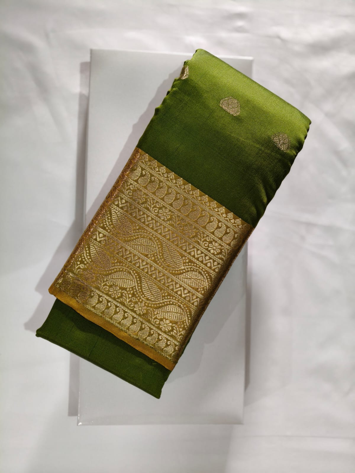 Olive Green Silk featuring a Wide, Opulent Gold Zari Border with Wavy Traditional Weaving