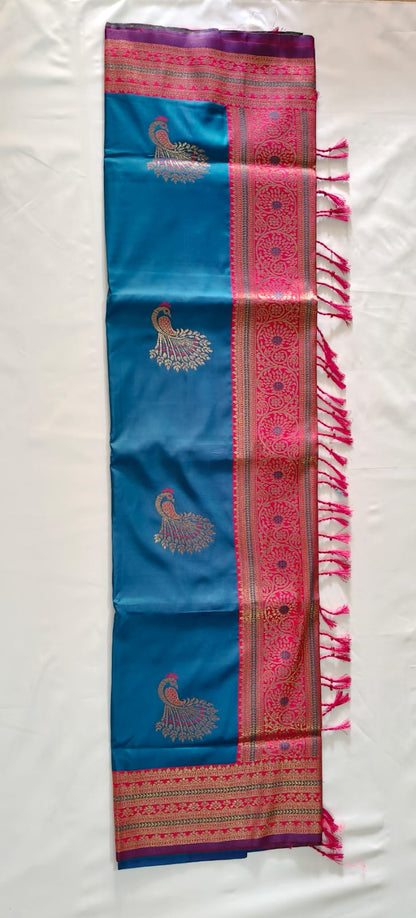 Teal Blue Banarasi Silk Paired with a Bold Pinkish Border and intricate Zari Peacock Motifs